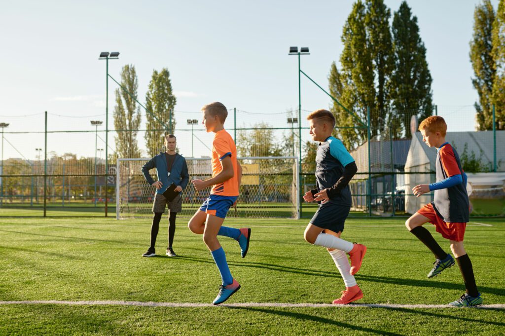 coach 360 - kids practicing soccer on grass field under footba 2023 11 27 05 11 41 utc